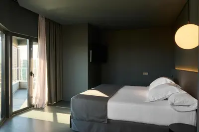 a bedroom with a bed with white sheets and pillows at Barcelona Princess in Barcelona