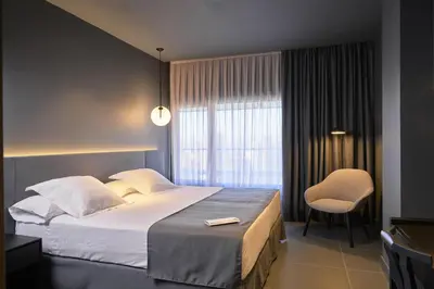 a hotel room with a bed and a chair at Barcelona Princess in Barcelona