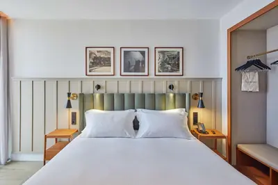 a bedroom with a large white bed with two pillows at Via Sants Hotel Barcelona, Tapestry Collection By Hilton in Barcelona