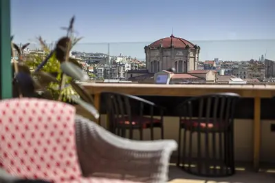a balcony with chairs and a view of a city at Via Sants Hotel Barcelona, Tapestry Collection By Hilton in Barcelona
