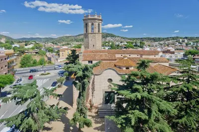 a building with a clock tower in a city at Mercè in Pineda de Mar