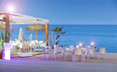 a group of tables and chairs on the beach at Mercè in Pineda de Mar