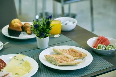 a table with plates of food on a table at BCN Urbaness Hotels Del Comte in Barcelona