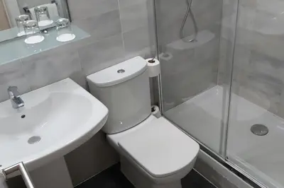 a bathroom with a toilet and a sink and a shower at BCN Urbaness Hotels Del Comte in Barcelona