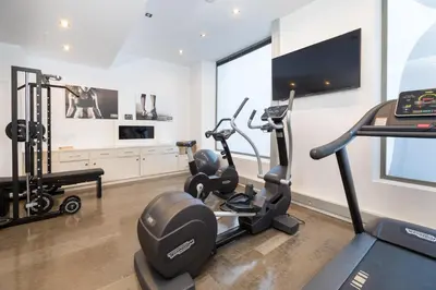 a gym with two treadmills and two ellipticals at Sercotel Amister Art Hotel Barcelona in Barcelona