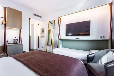 a hotel room with two beds and a flat screen tv at Best Western Plus Hotel Alfa Aeropuerto in Barcelona