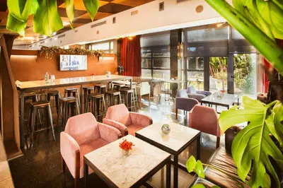 a restaurant with tables and chairs and a bar at Best Western Plus Hotel Alfa Aeropuerto in Barcelona