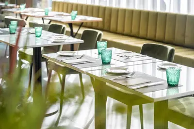 a row of tables and chairs in a restaurant at Hesperia Barcelona Sant Just in Sant Just Desvern