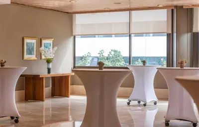 a room with white tables and a large window at Hesperia Barcelona Sant Just in Sant Just Desvern