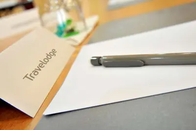 a notebook on a table with a pen on it at Travelodge Barcelona del Vallés in Barbera del Valles