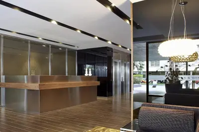 a kitchen with black cabinets and a chandelier at AC Hotel Victoria Suites by Marriott in Barcelona