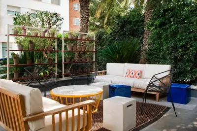 a patio with chairs and a couch and a table at AC Hotel Victoria Suites by Marriott in Barcelona