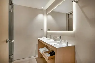 a bathroom with a sink and a mirror at AC Hotel Victoria Suites by Marriott in Barcelona