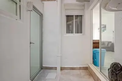 a hallway with a glass door in a room at apartamento con calefaccion y parkig privado gratis in Badalona
