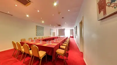a long conference room with a long table and chairs at Silken Sant Gervasi in Barcelona