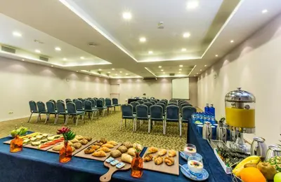 a conference room with a table with food and chairs at Leonardo Hotel Barcelona Gran Via in Barcelona