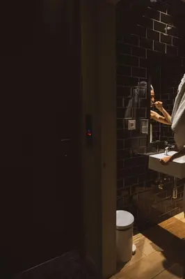 a bathroom with a person taking a picture in the mirror at TOC Hostel Barcelona in Barcelona