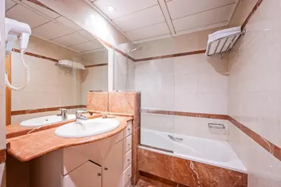 a bathroom with a sink and a tub at Apartaments Marina - Abapart in Barcelona