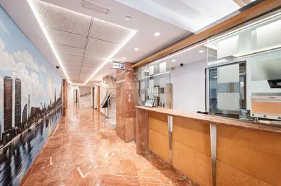 a long hallway with a bar in a building at Aparthotel Napols - Abapart in Barcelona