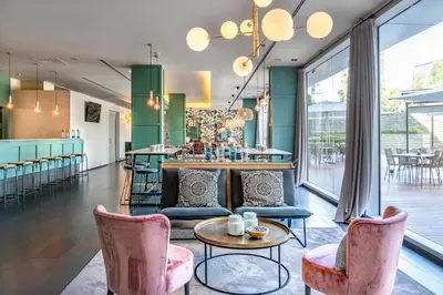 a restaurant with tables and chairs and windows at Vincci Maritimo in Barcelona