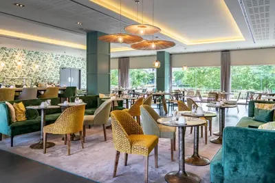 a table with chairs and a wall with mirrors at Vincci Maritimo in Barcelona