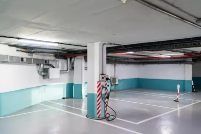 an empty parking garage with a red and white pole at Hotel Concordia Barcelona in Barcelona