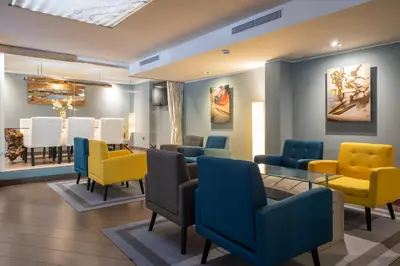 a waiting room with colorful chairs and a table at Hotel Concordia Barcelona in Barcelona