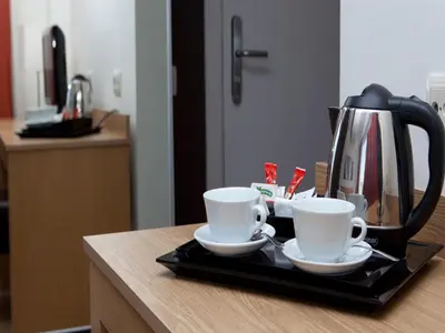 a tray with two coffee cups and a tea kettle at Hotel Sagrada Familia in Barcelona