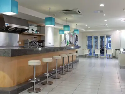 a kitchen with a bar with stools at Hotel Sagrada Familia in Barcelona