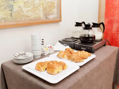 a table with two plates of croissants and a blender at Hotel Sagrada Familia in Barcelona