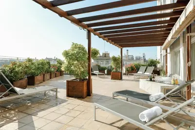 a patio with chairs and tables on a building at Hesperia Barcelona Presidente in Barcelona