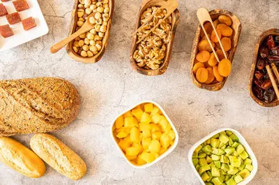 a table topped with baskets of different types of food at Hesperia Barcelona Presidente in Barcelona