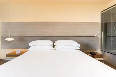 a bedroom with a large white bed with two pillows at B Hotel in Barcelona