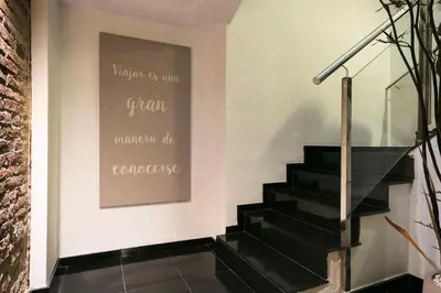 a staircase with black stairs and a sign on the wall at Hotel Best Auto Hogar in Barcelona