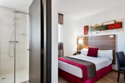 a hotel room with a bed and a shower at Hotel Best Auto Hogar in Barcelona