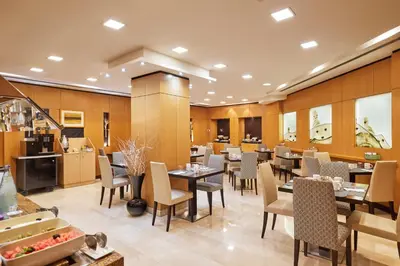 a restaurant with tables and chairs in a room at Eurostars Monumental in Barcelona