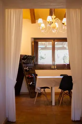 a dining room with a table and a wine cellar at Cal Colina - Karaktervol landhuis met privé zwembad in Pacs del Penedes
