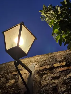 a light on the side of a stone wall at Cal Colina - Karaktervol landhuis met privé zwembad in Pacs del Penedes