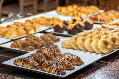 a display of different types of pastries and donuts on plates at Sunotel Aston in Barcelona