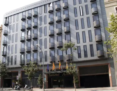 a large building with flags in front of it at Sunotel Aston in Barcelona