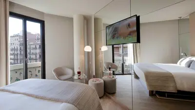 a bedroom with a bed and a flat screen tv at Cram Hotel in Barcelona