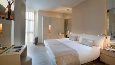 a bedroom with a large white bed in a room at Cram Hotel in Barcelona