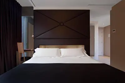 a bedroom with a large bed with a black headboard at Axel Hotel Barcelona - Adults Only in Barcelona
