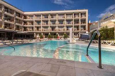 a large swimming pool in front of a hotel at Aparthotel Miami Park in Calella