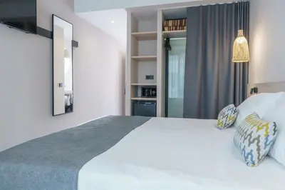 a bedroom with a large white bed and a mirror at DWO Les Palmeres in Calella