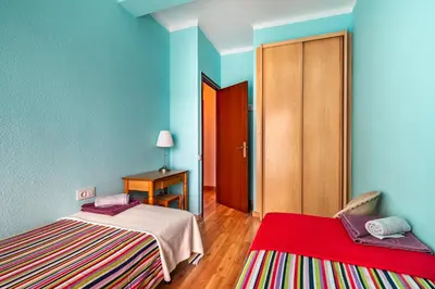 two beds in a room with blue walls at Dream House in Badalona