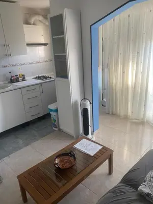 a living room with a coffee table and a kitchen at 3 BDRM APART NEAR THE SEA! GREAT FOR KIDS! in Arenys de Mar