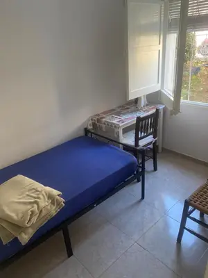 a bedroom with a bed and a desk and a chair at 3 BDRM APART NEAR THE SEA! GREAT FOR KIDS! in Arenys de Mar