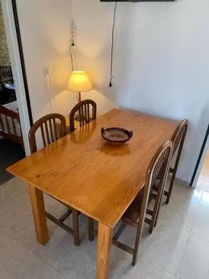 a wooden dining room table with chairs and a lamp at 3 BDRM APART NEAR THE SEA! GREAT FOR KIDS! in Arenys de Mar