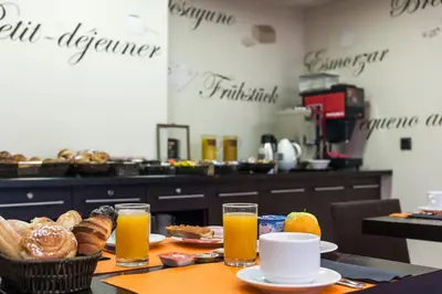 a table with orange juice and bread and drinks at Acta Antibes in Barcelona